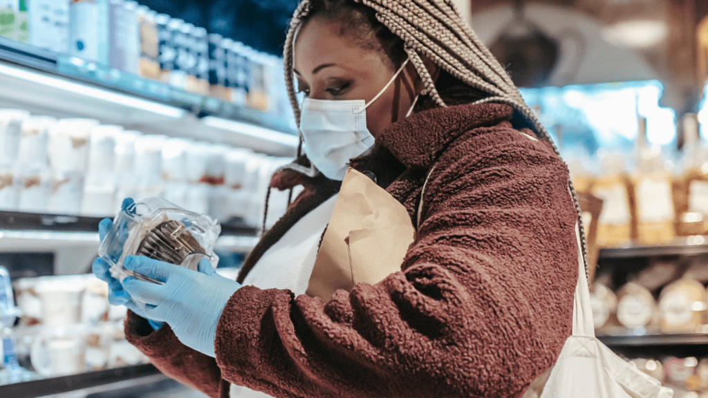 a person wearing a face mask in a grocery store