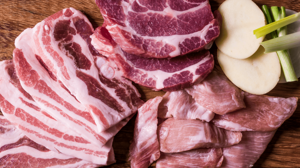 assorted cuts of meat on a cutting board