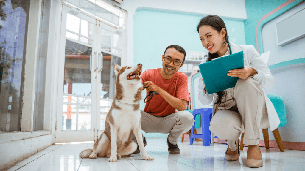 a person with a dog in the vet office