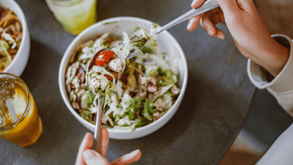 a bowl filled with vegetables and dressing