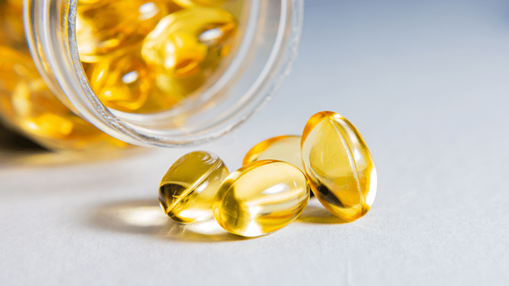 a bowl full of fish oil capsules on a white surface