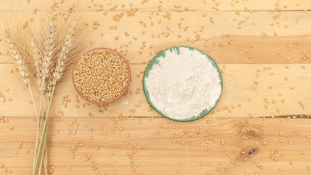 wheat seeds in a wooden bowl on a wooden table